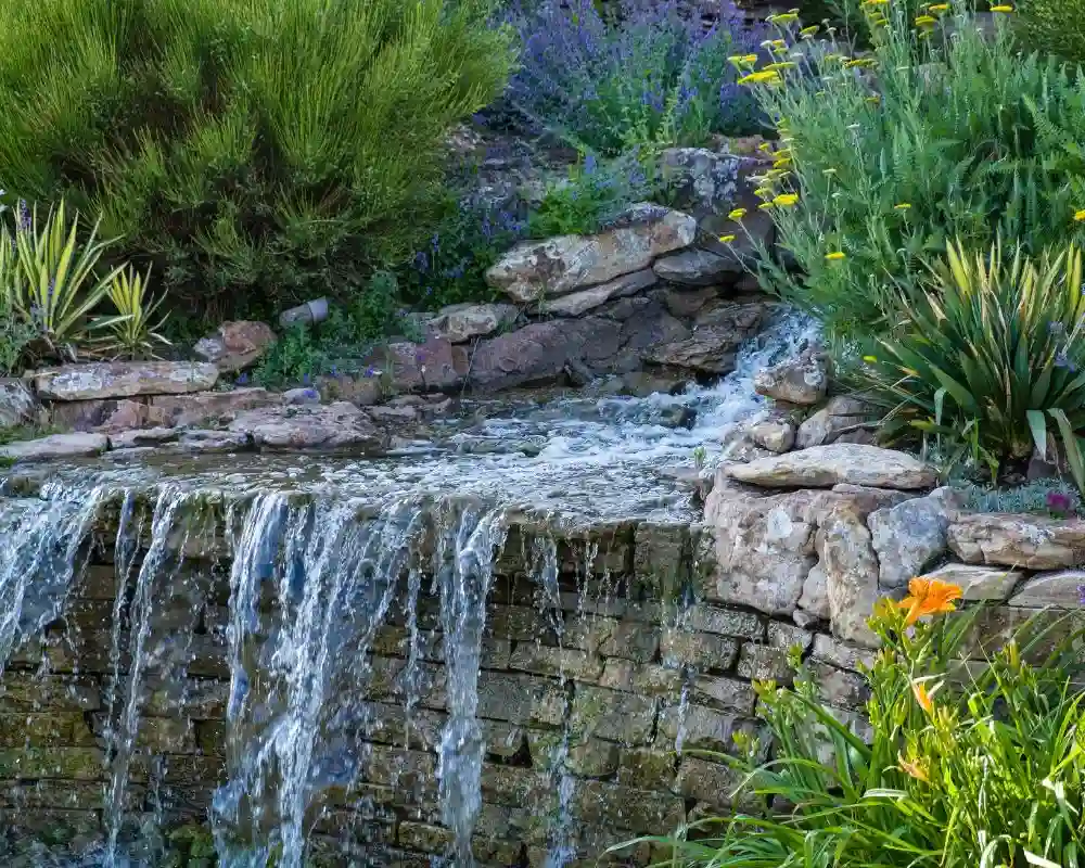 professionally structured stacked stone retaining wall waterfall
